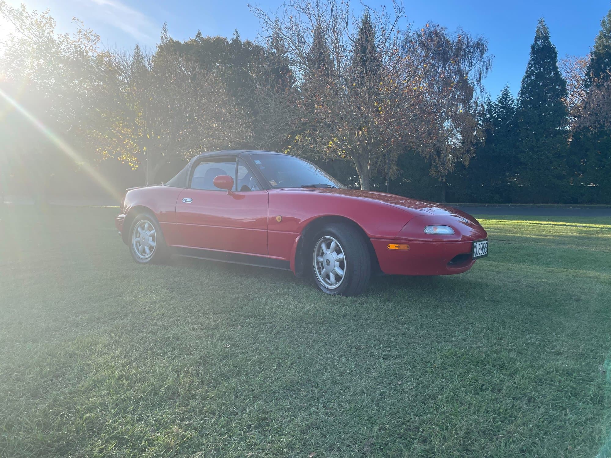 1989 Eunos Roadster XU6055 -- side profile, soft top up, golden hour